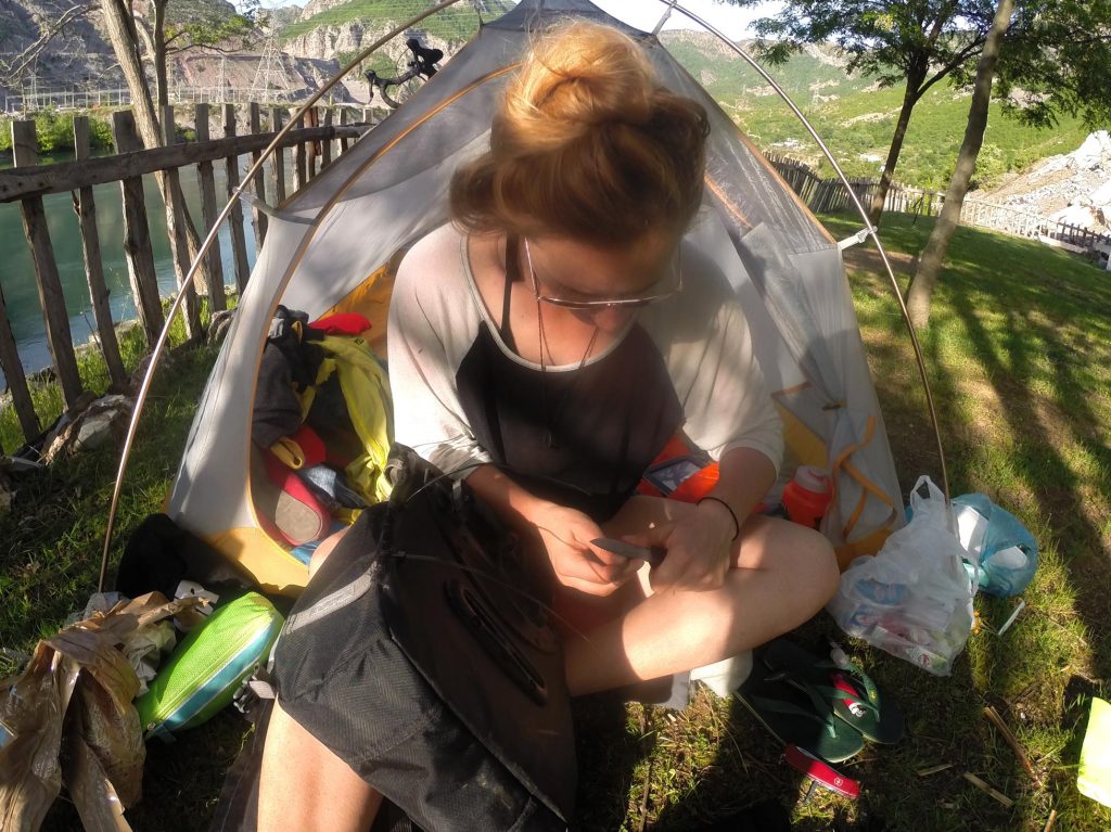 Sewing my pannier back together in rural Albania, at the base of a dam. We camped out in the yard of the owner of a tiny shop across the road.