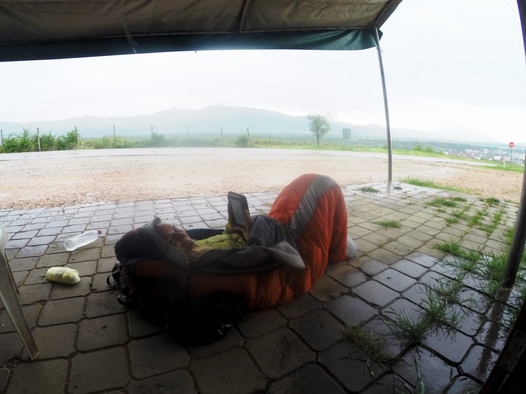 When waiting out the rain in Greece, pull out the sleeping bag to stay warm.